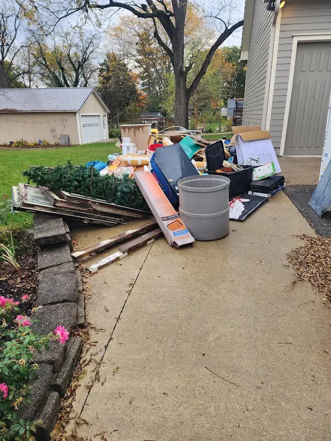 Dumpster being loaded with debris for Commercial Dumpster Rental in Raymore